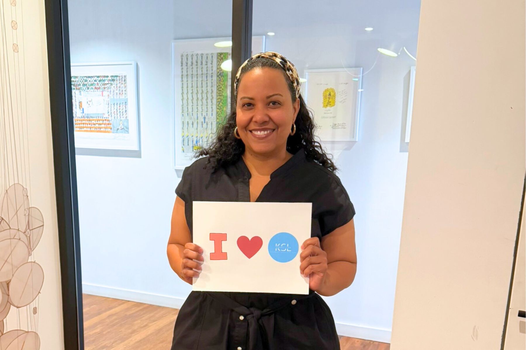 Workshop participant holding up an "I [heart] KSL" sign.